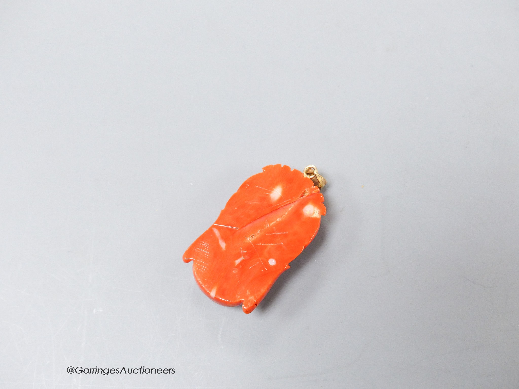 A Chinese 14k yellow metal mounted carved coral pendant, 35mm, gross weight 8.9 grams.